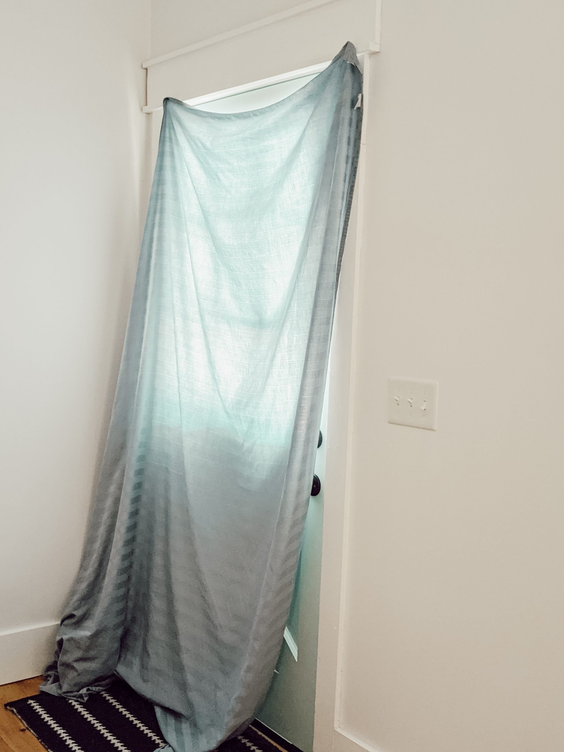 blue bedsheet as temporary curtain