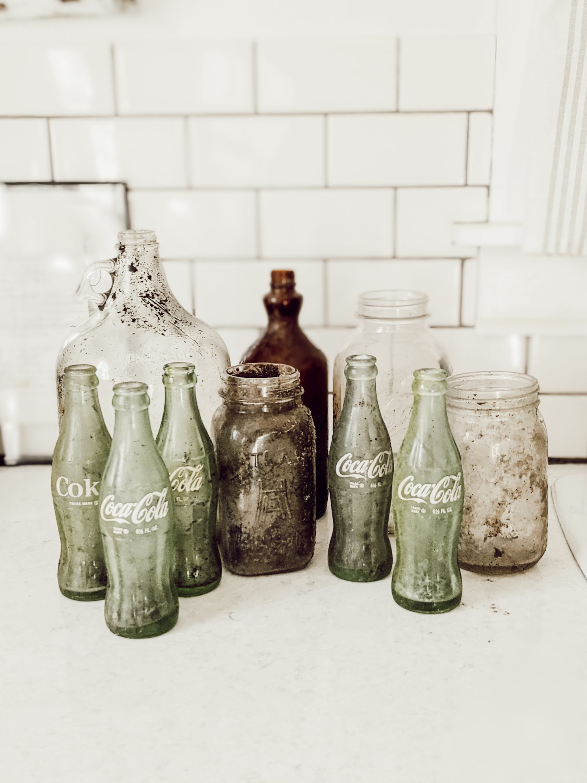 how to clean glass bottles like these dirty vintage glass bottles and jars