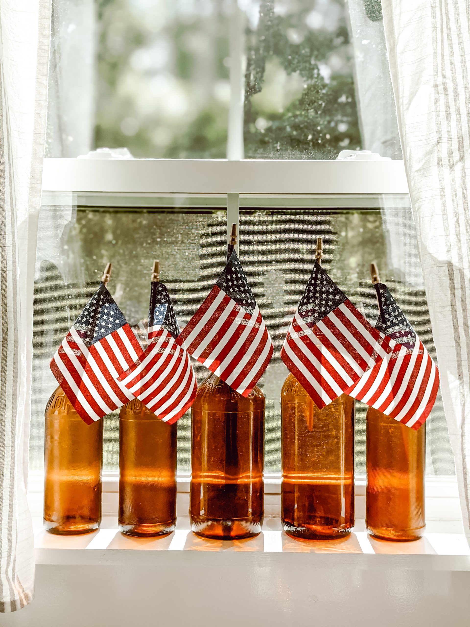 mini flags in amber glass clorox bottles