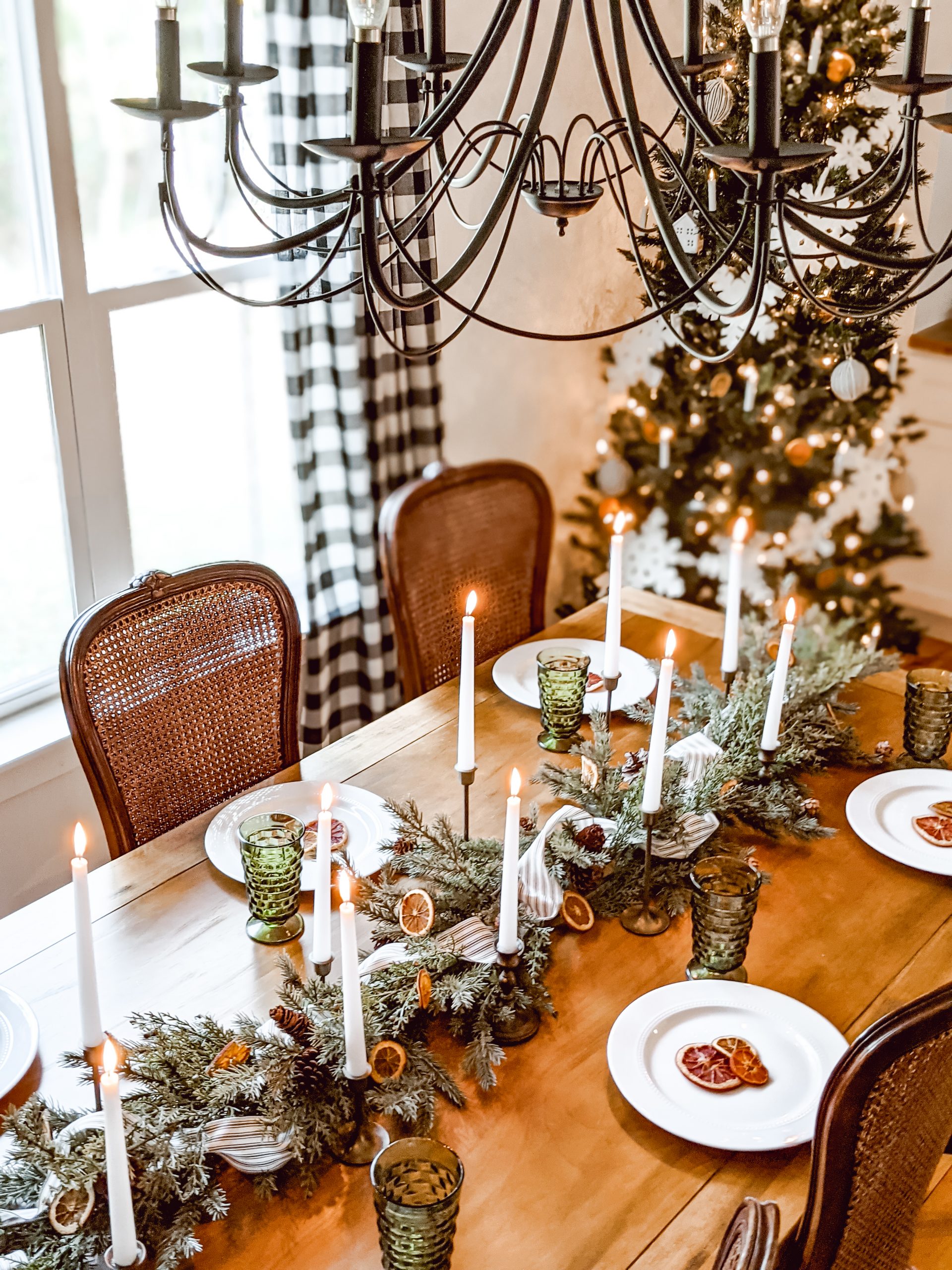 farmhouse christmas tablescape with orange slices, ticking ribbon and brass candlesticks