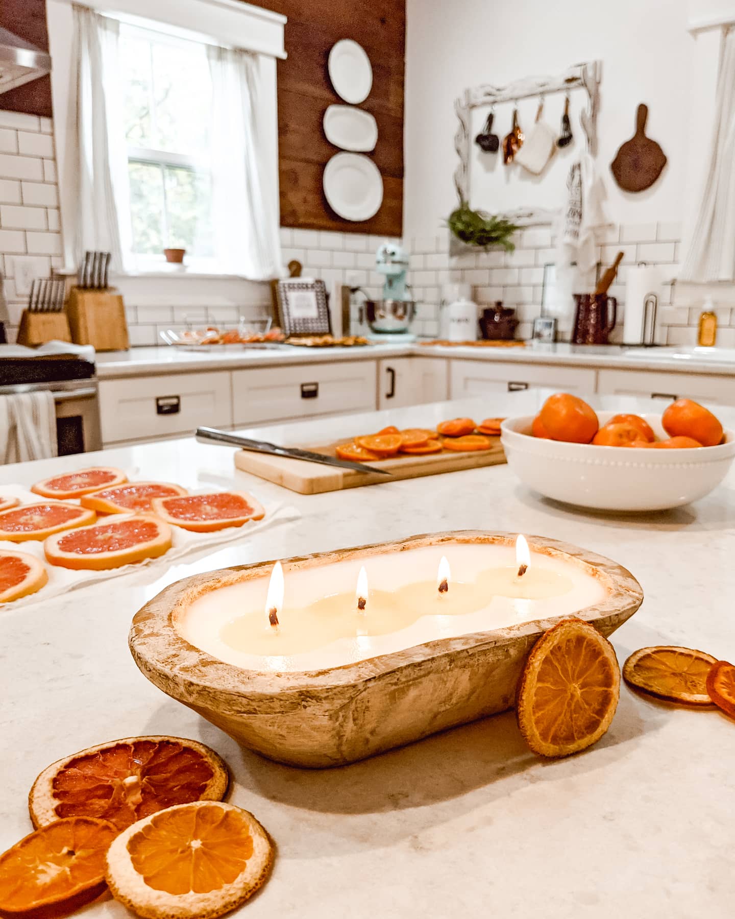 sliced citrus fruit and dough bowl candle