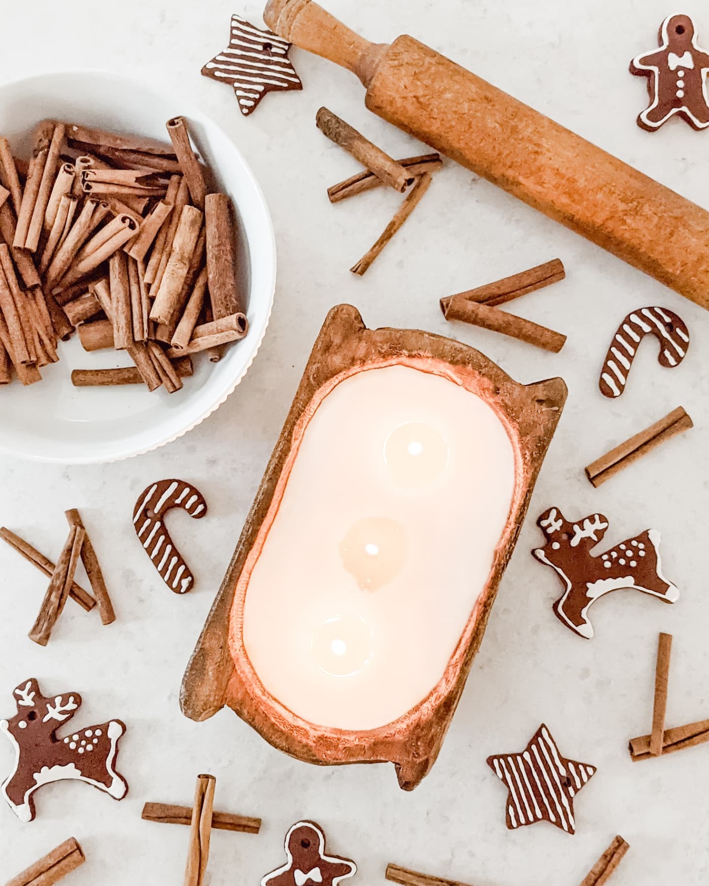 dough bowl candle, cinnamon sticks, rolling pin and gingerbread men