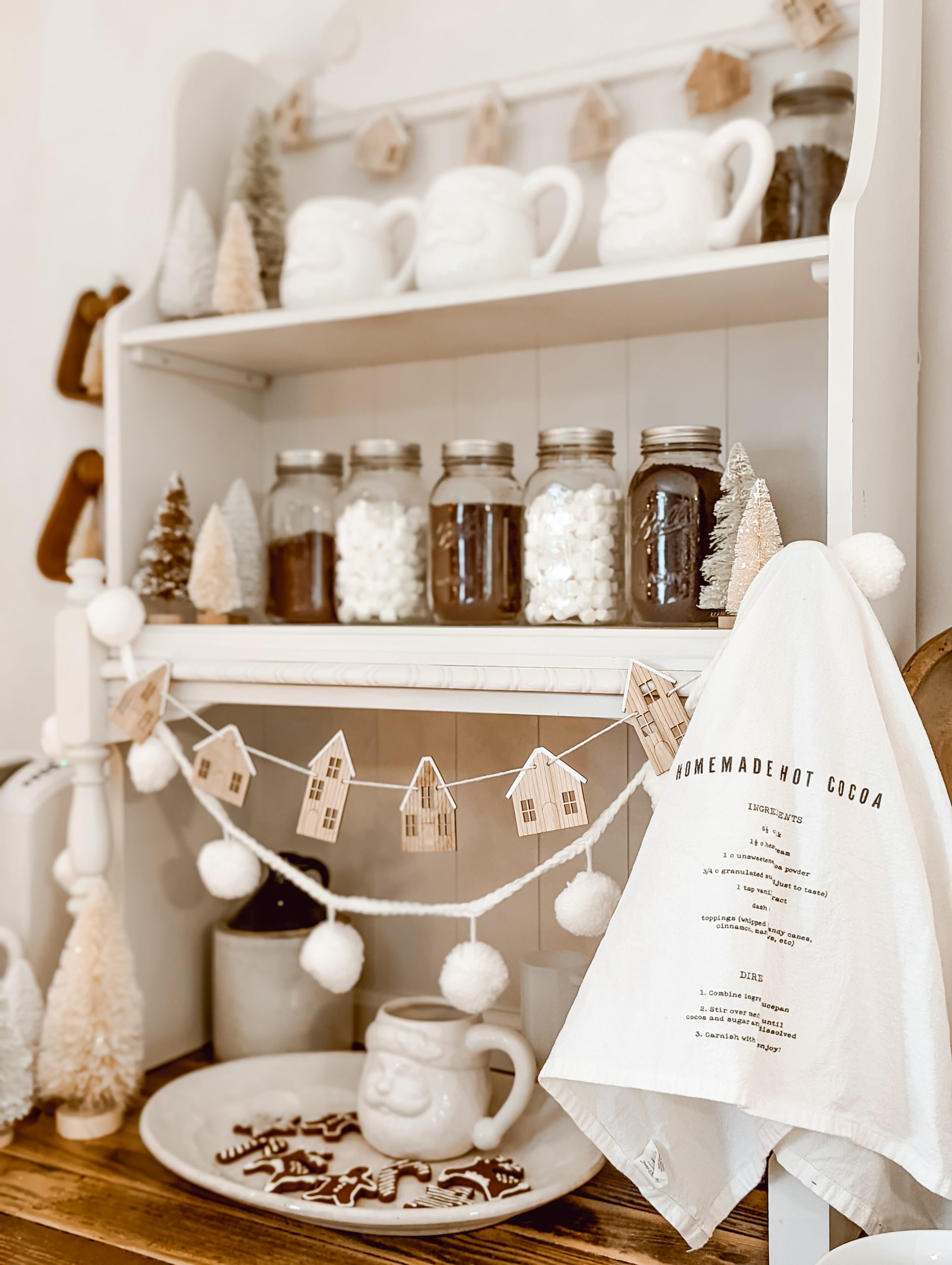 neutral Christmas coffee bar with white Santa mugs and vintage wood decor