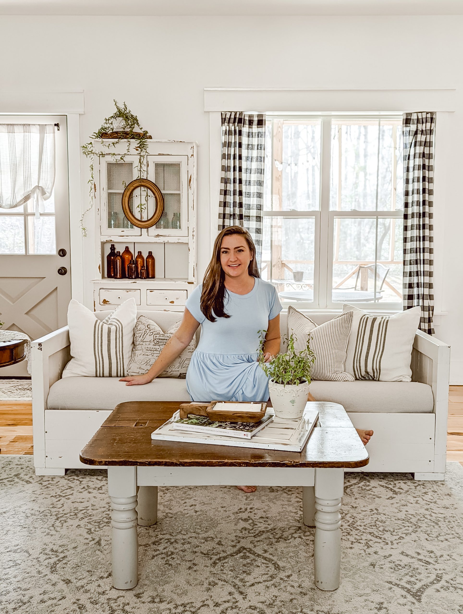 Blogger Brittany Hutchison of White & Woodgrain in farmhouse living room as featured in Landleben Magazine