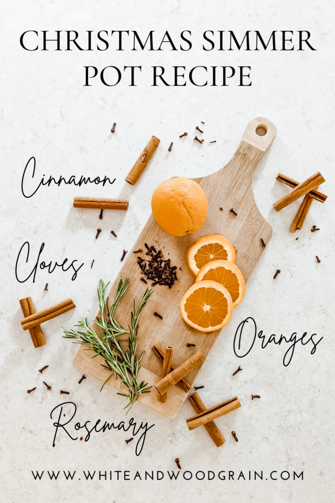 Christmas simmer pot recipe and ingredients arranges on wooden cutting board with cinnamon sticks, cloves, oranges, and rosemary