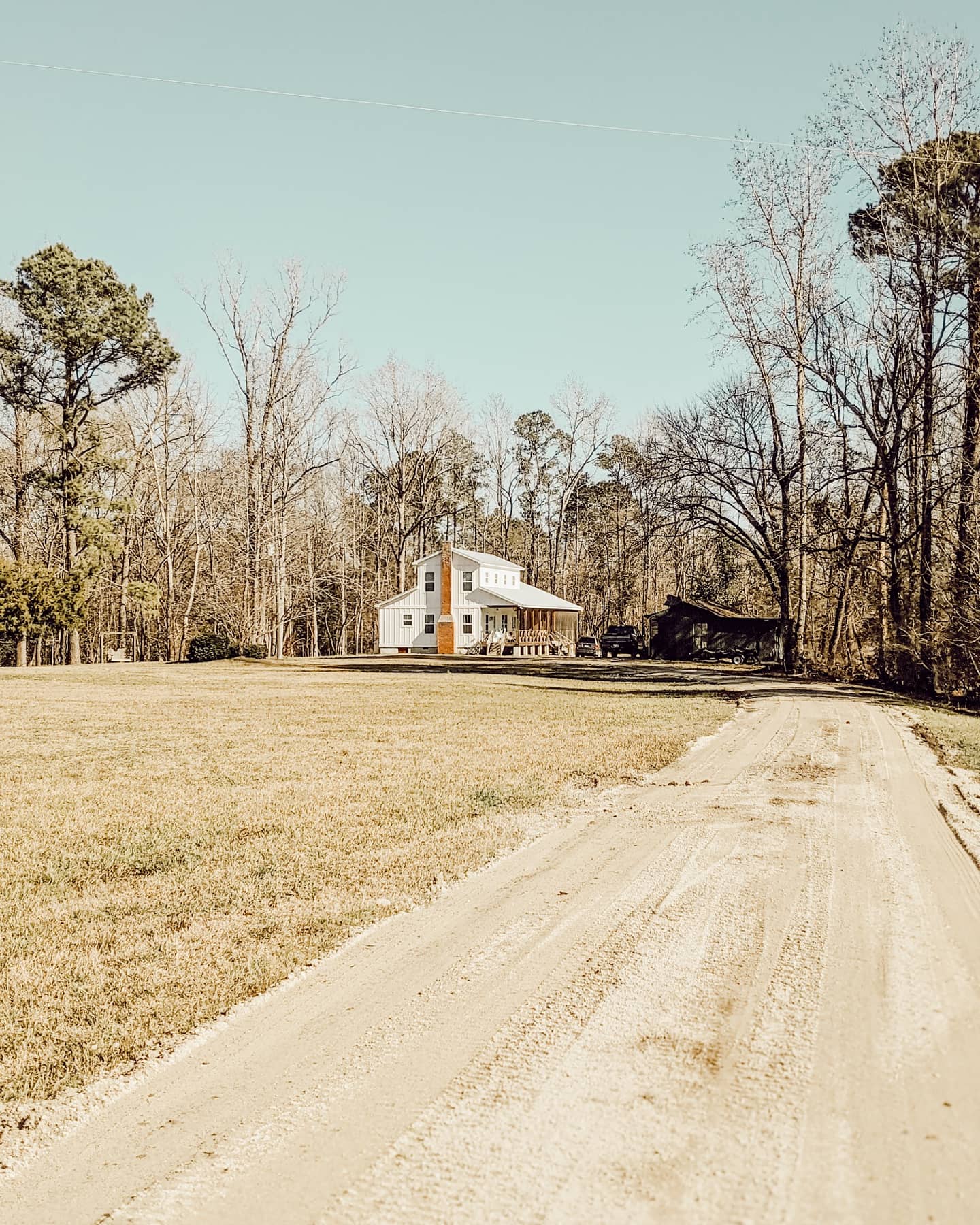 White farmhouse at the end of an old dirt road