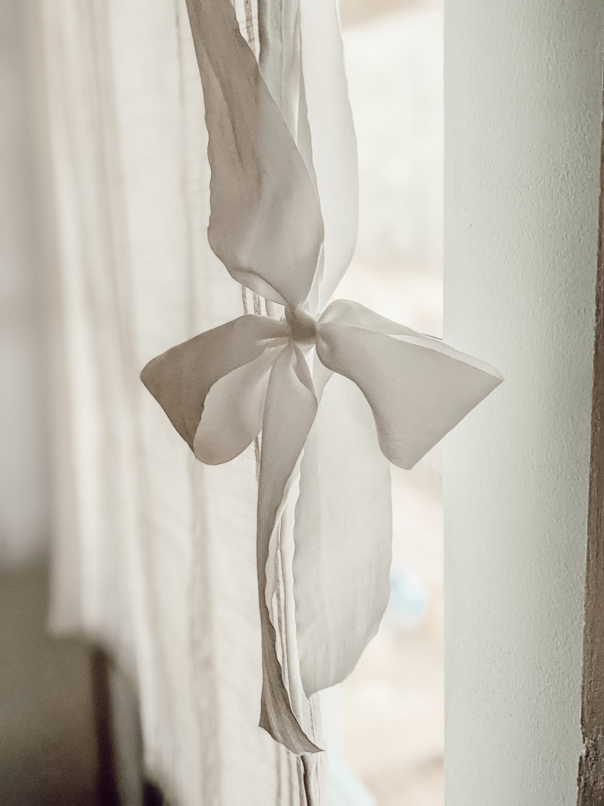 delicate white bow on tie-up curtain