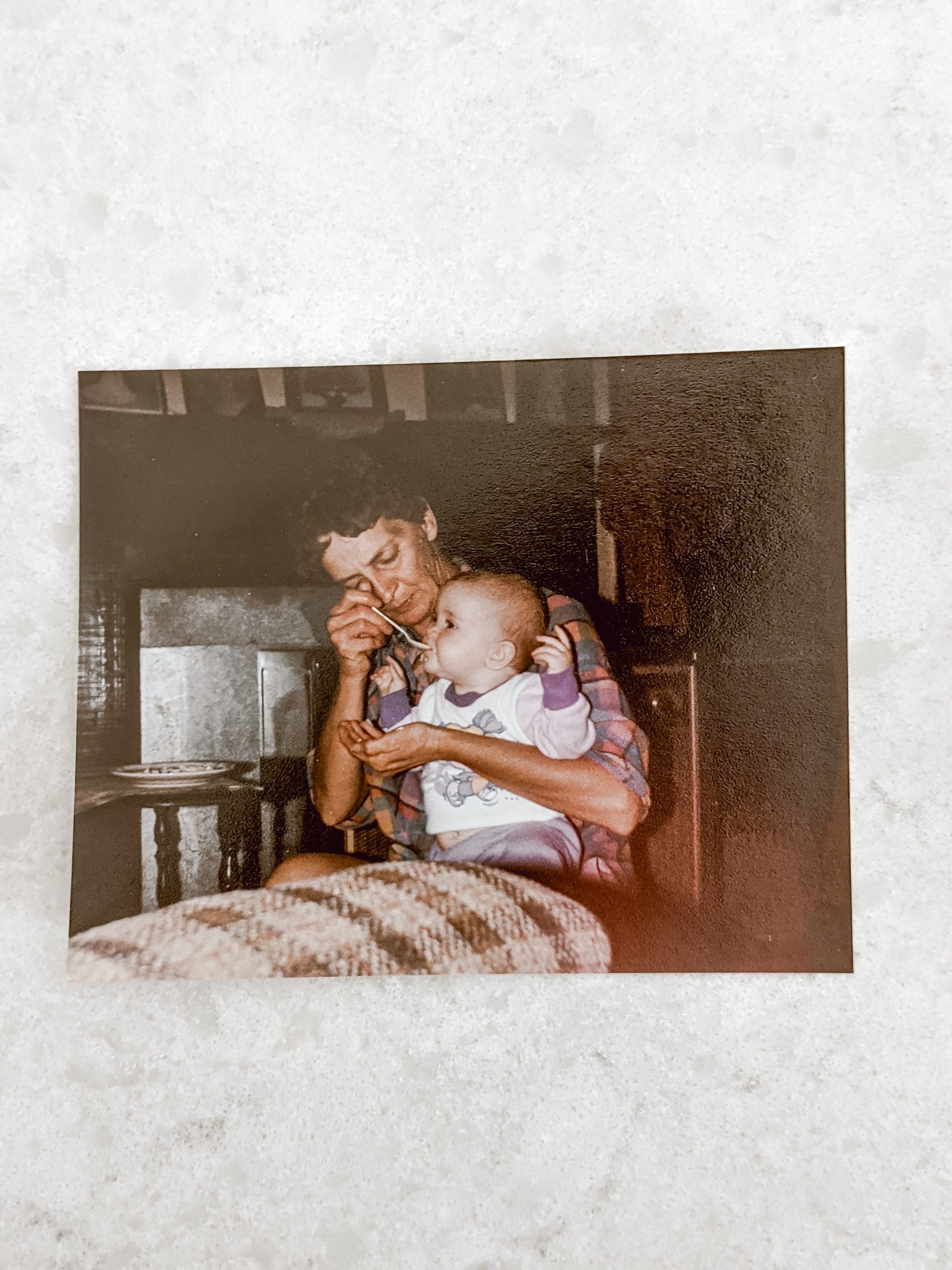 grandmother feeding baby in an early 1990's family photo