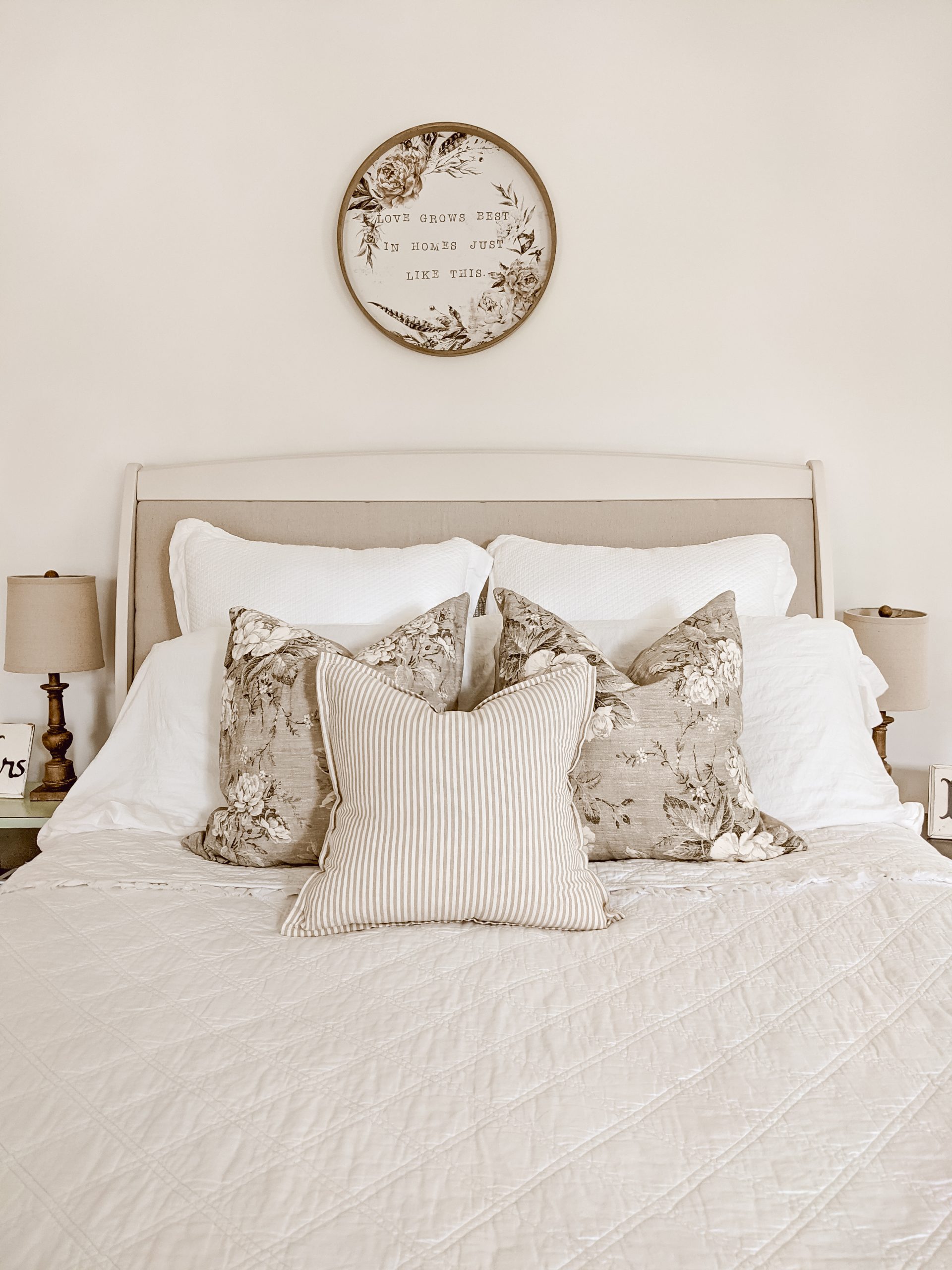 white cottage farmhouse style bedding and upholstered headboard