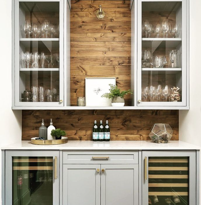 glass cabinet built-ins with wood panel wall