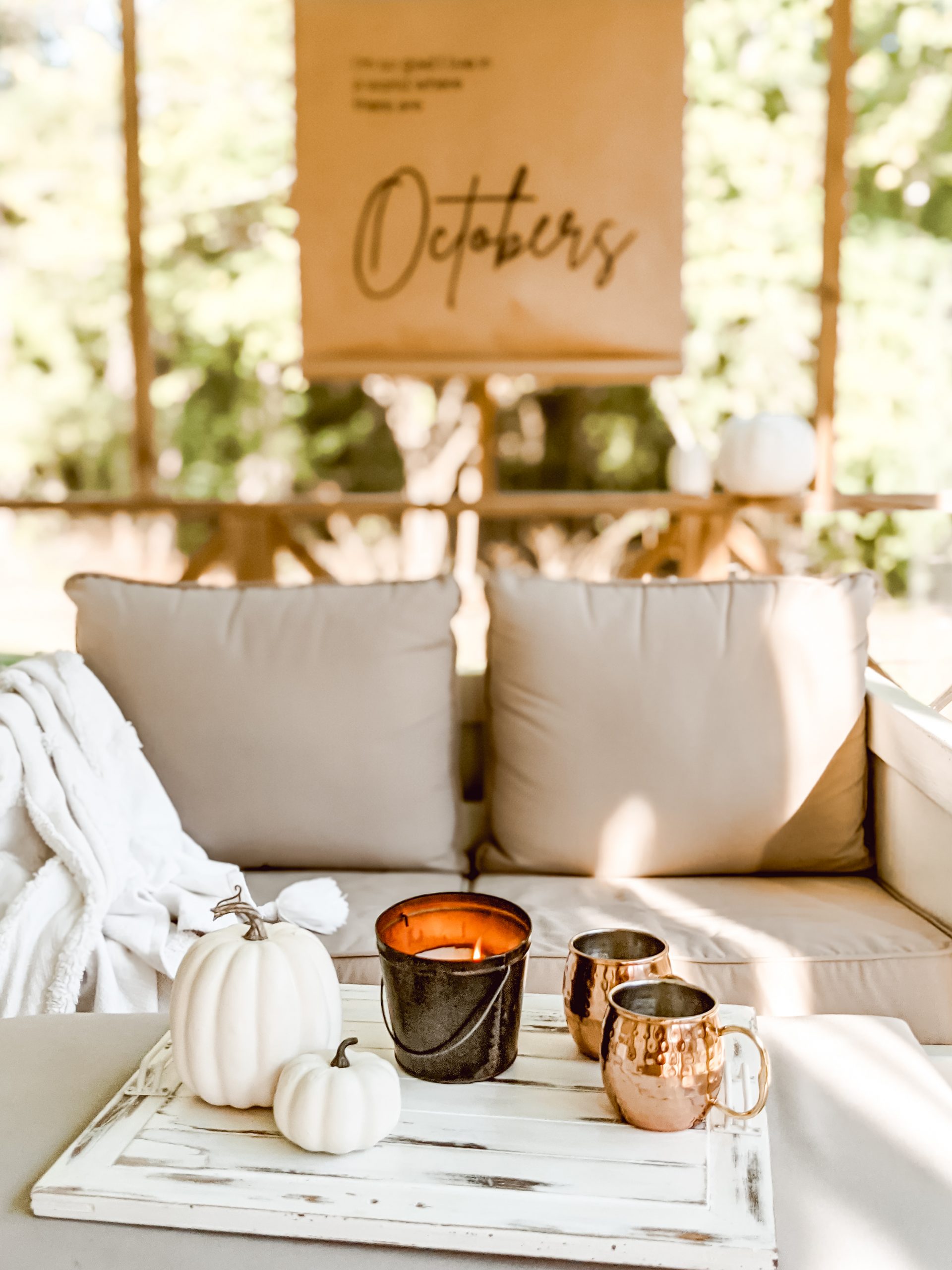 pumpkins, citronella candle and copper mugs