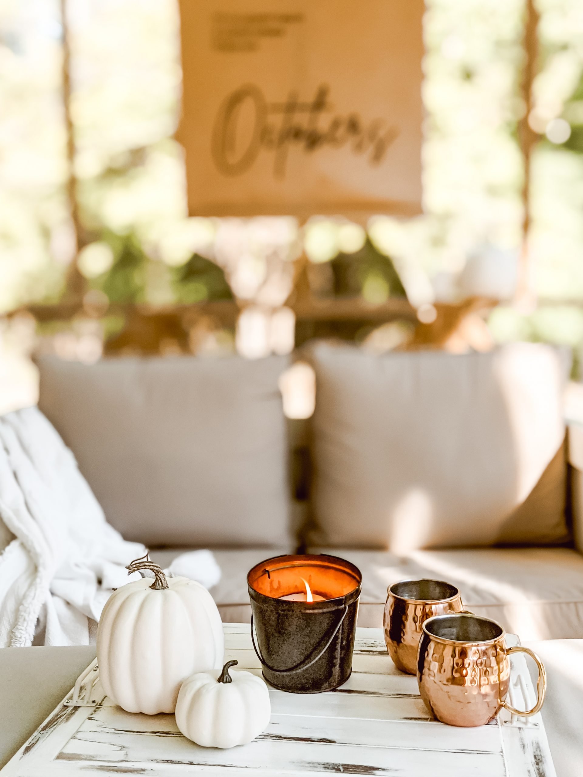 white faux pumpkins and copper mugs for fall