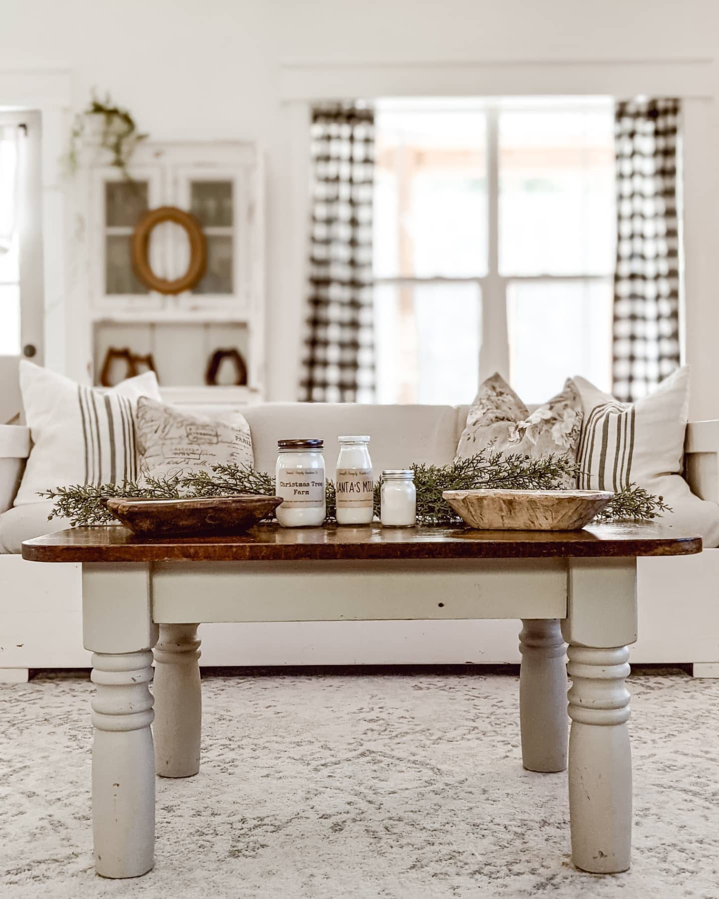 cozy white cottage and farmhouse style living room with soy candles on the coffee table