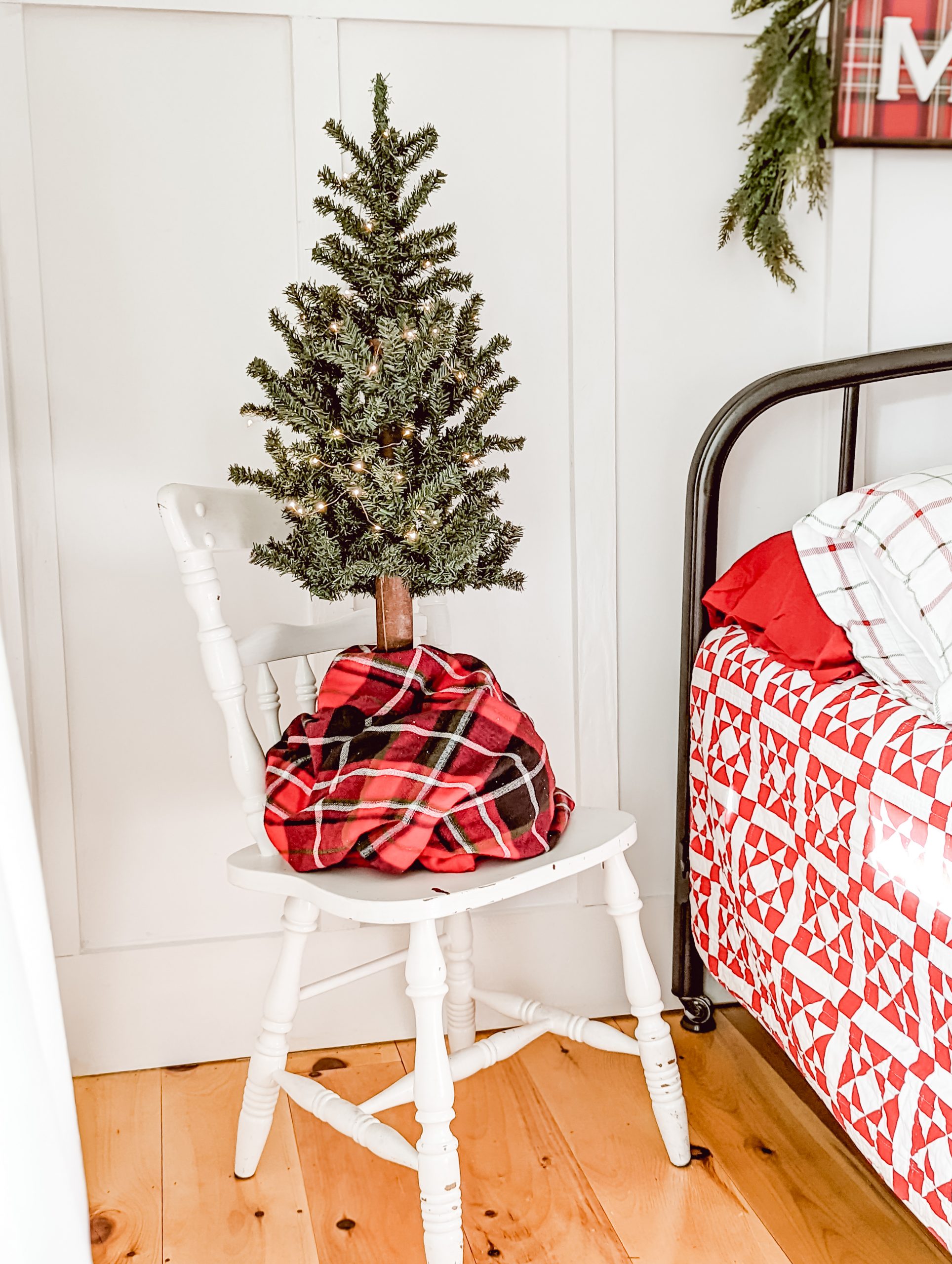 rustic natural Christmas tree with red plaid tree skirt