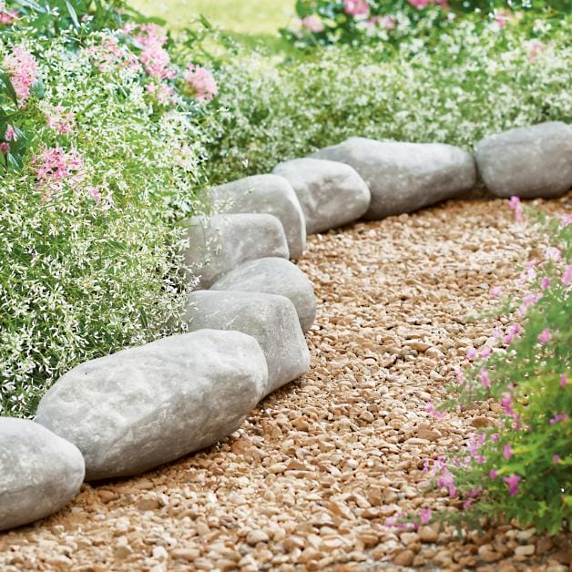 french country farmhouse landscape ideas with faux stone edging