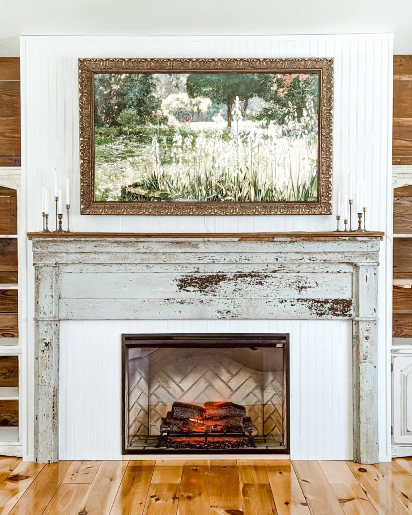 farmhouse cottage style fireplace with electric insert and frame TV above the antique mantel