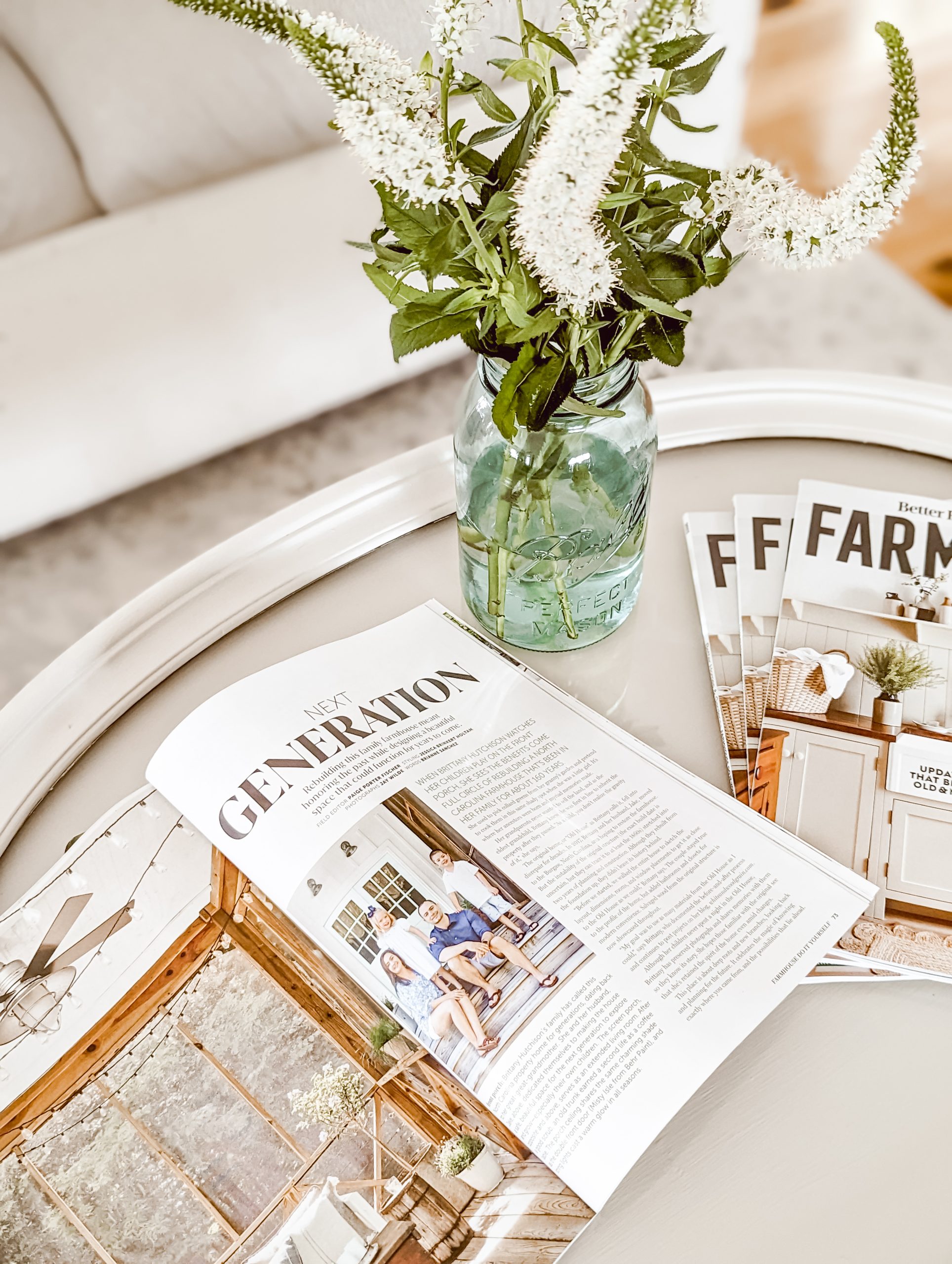 pretty white flowers in a blue mason jar and a peek inside our home's feature in BHG
