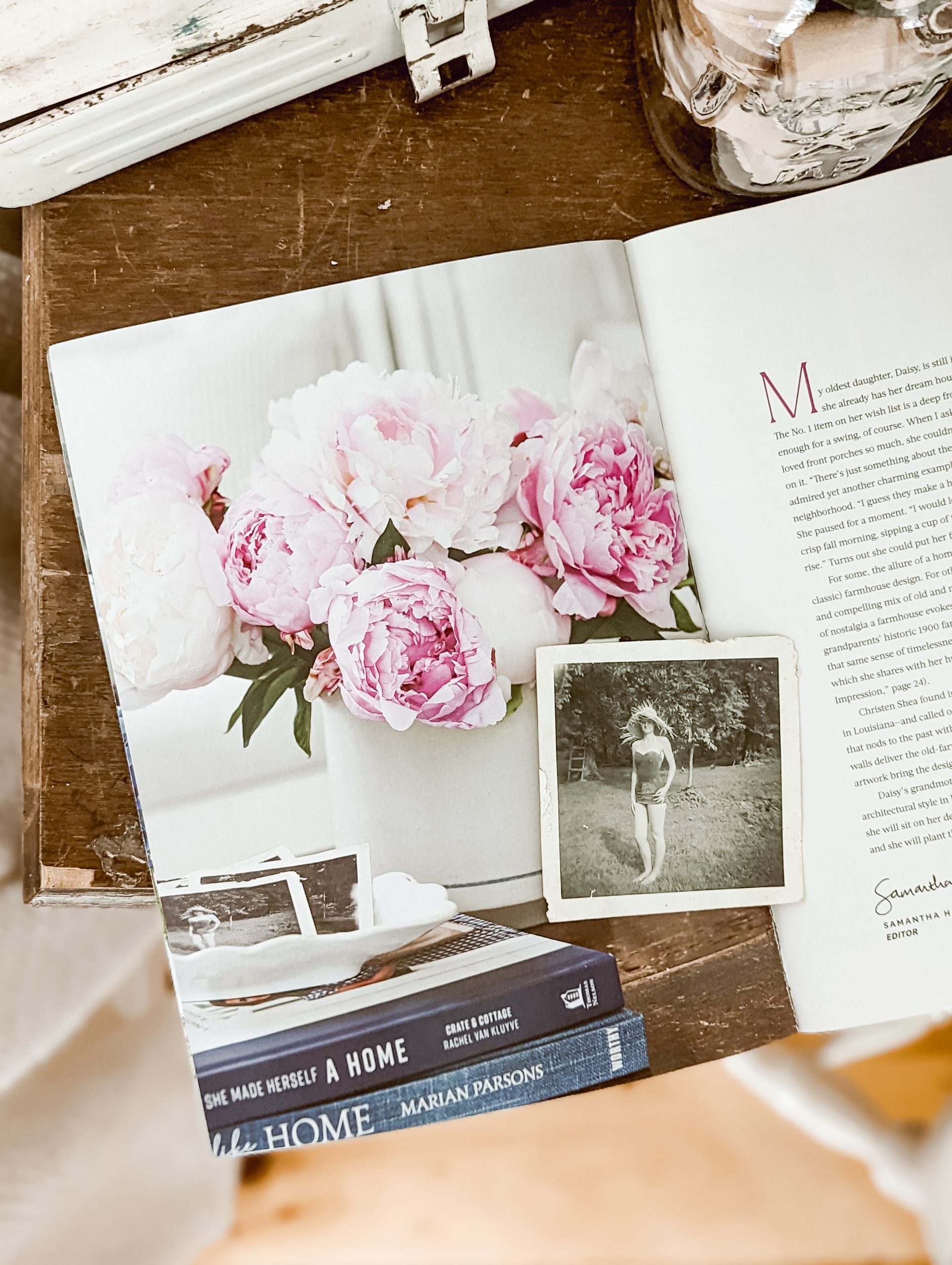 magazine spread with photo of pink peony arrangement and a collection of old black and white family photographs