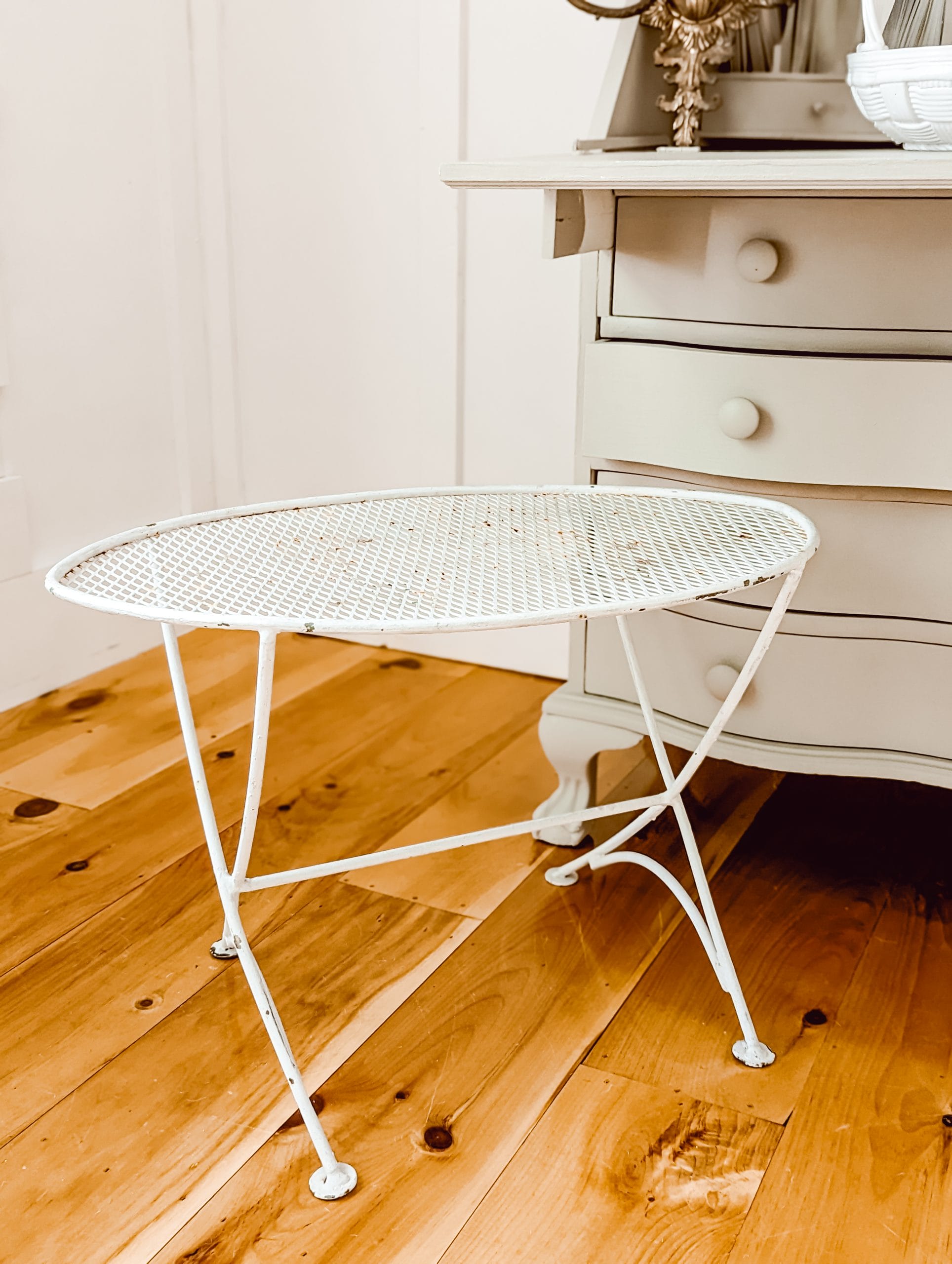 chippy white painted metal outdoor table