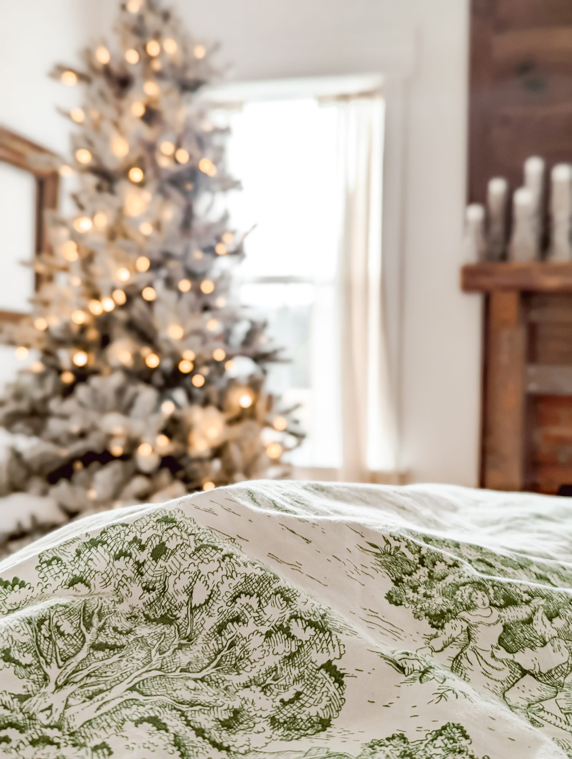 vintage green toile duvet cover with a flocked christmas tree in the background