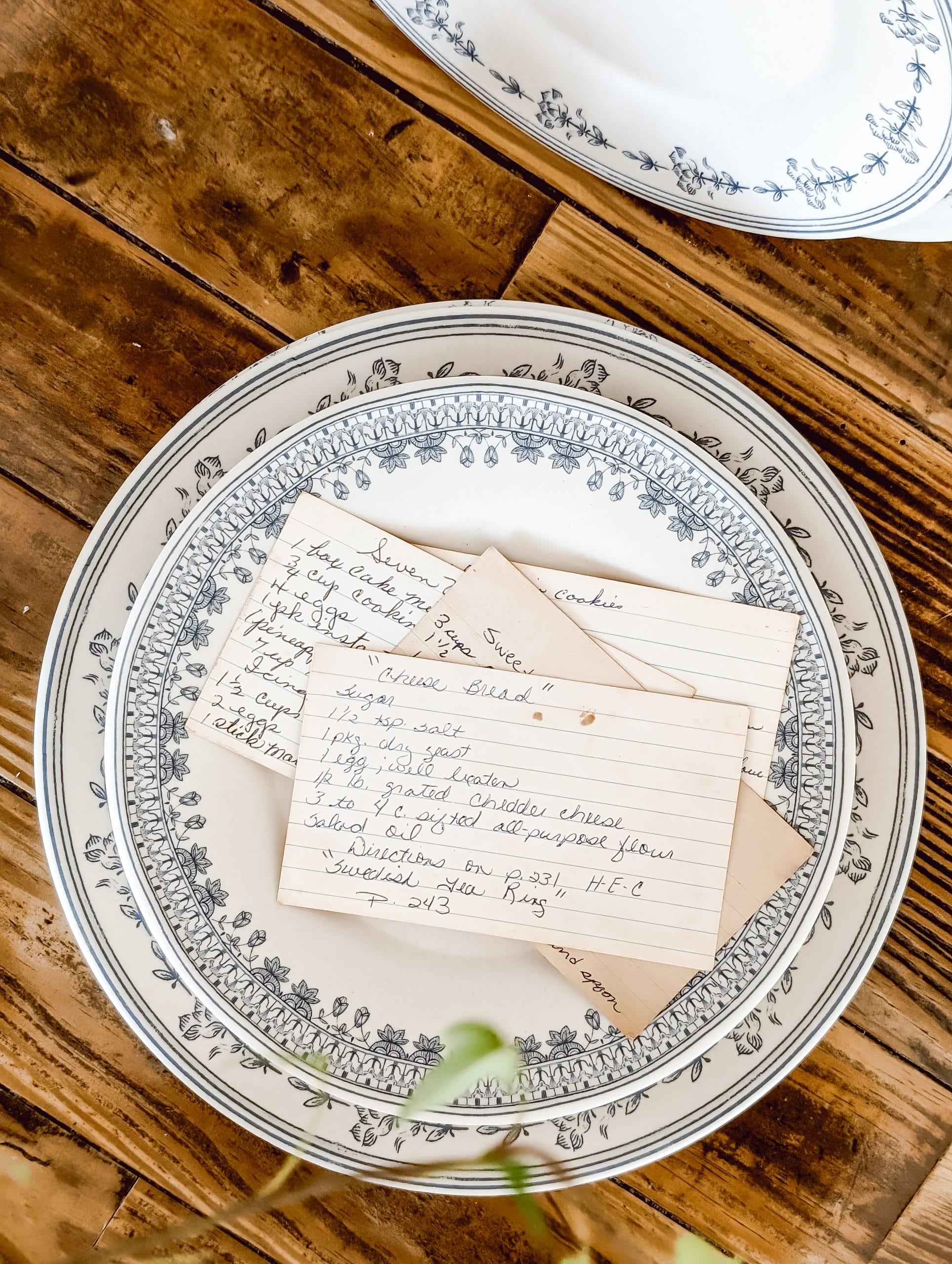 vintage style blue floral melamine plates from the Studio McGee line at Target topped with a few handwritten recipe cards 